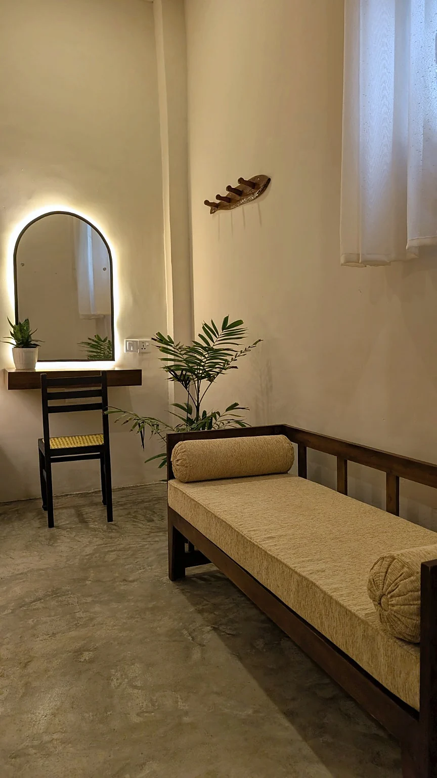 Daybed corner with an arched mirror and dressing chair